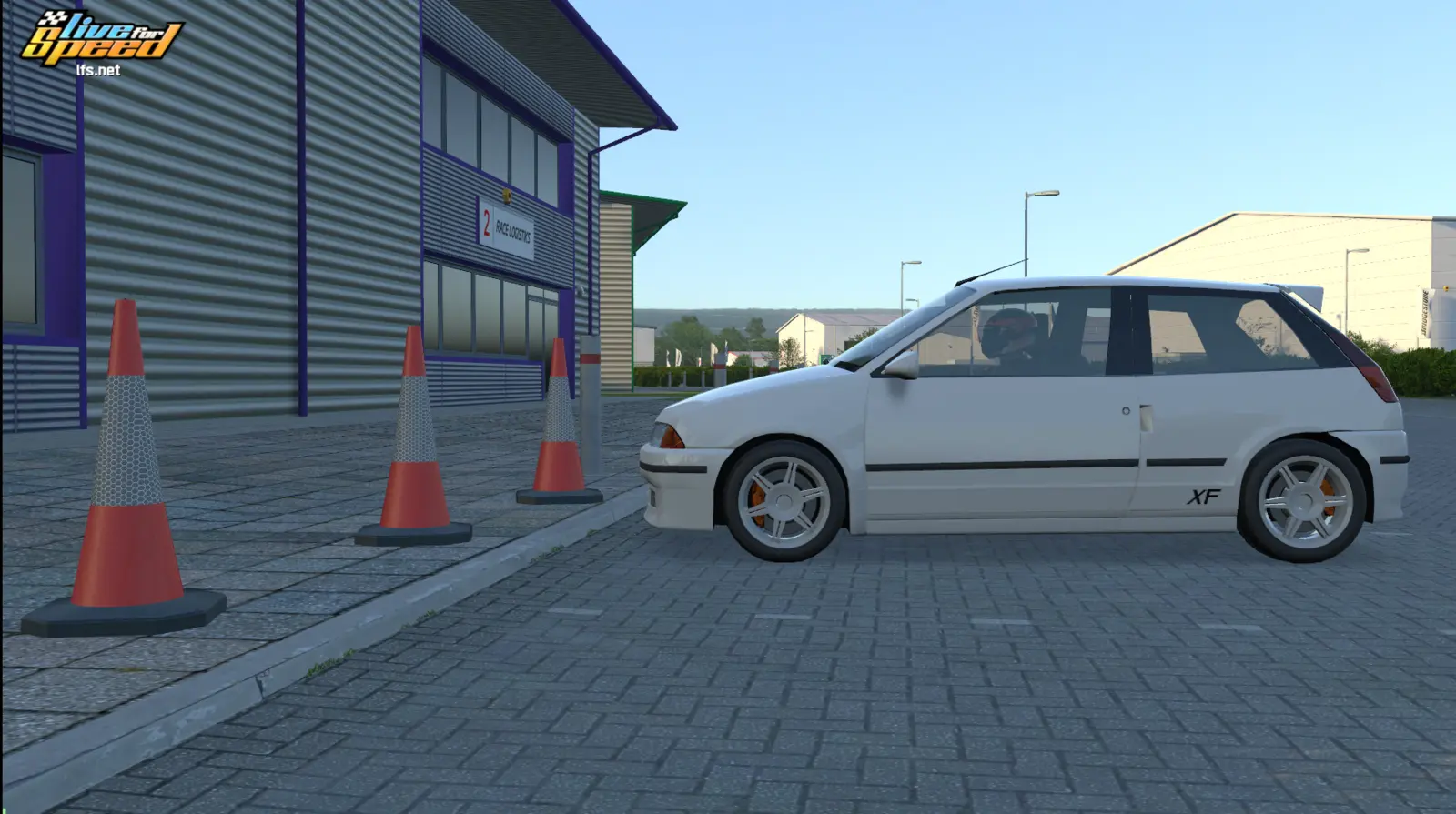 White hatchback parked beside cones in the Aussie Cruise BL1X industrial layout